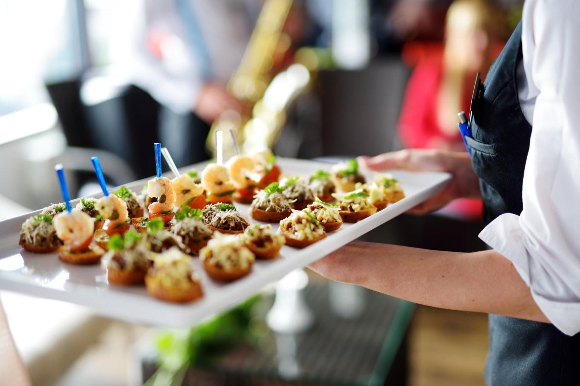 Crowne Plaza Changi Airport, An Ihg Hotel Singapore Exterior photo The photo shows a tray of appetizers being held by a waiter. The tray is filled with various small bites that appear to be decorative and gourmet. Some of the appetizers feature toppings such as shrimp and what looks like a mix of herbs or spreads. T